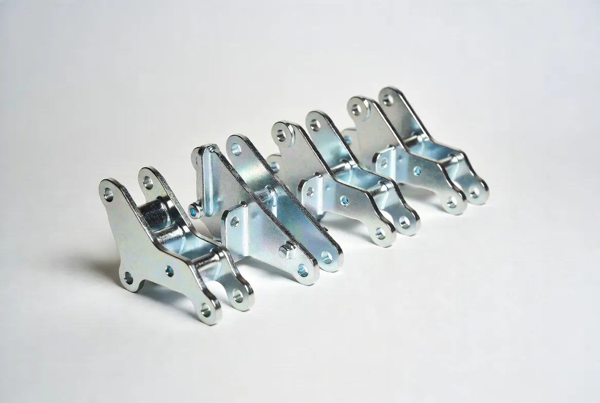 Multiple identical zinc-plated CNC steel industrial brackets and connecting parts arranged neatly in a row on a white background.
