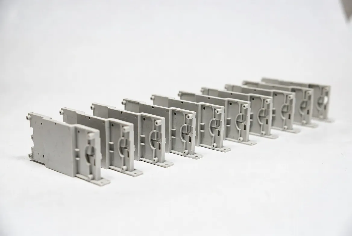 Multiple identical ABS CNC precision plastic components arranged neatly in a row on a white background.