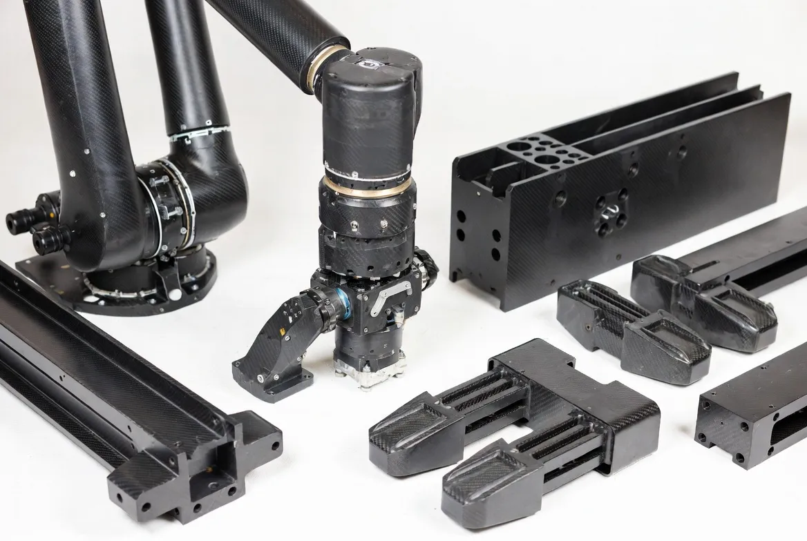 Carbon fiber composite robotics parts: high-speed robot arms, structural beams and lightweight end-effectors with woven carbon texture on clean white background